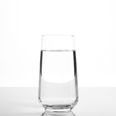 Glass of water on light background