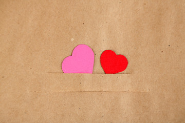 Paper hearts on brown background, close up