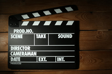 Movie clapper on wooden background