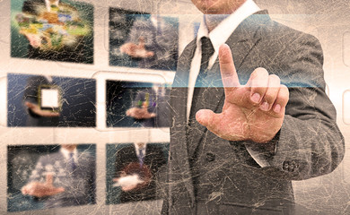 businessman hand pushing button on a touch screen interface in t