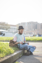 young handsome hipster gay modern man using tablet