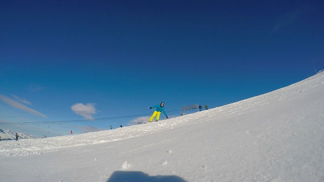 Skier touching snow with hand, slowmotion