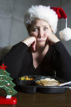 Unhappy Woman Having TV Dinner For Christmas