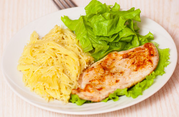 chicken breast with pasta and salad