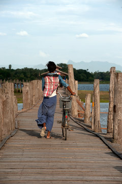 Villagers bike trailers on U-Bein Bridge,Myanmar.