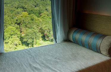 Bed beside window.