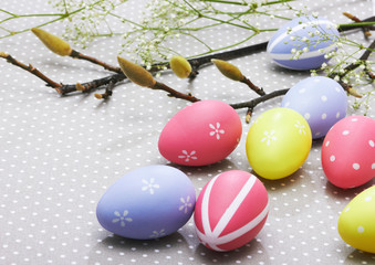 colorful easter eggs on background with spring flowers