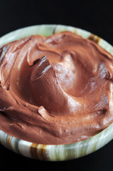 Red cosmetic clay in onyx bowl