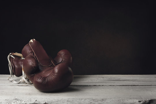 Boxing Gloves lying on wooden Planks