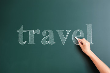 travel written on blackboard