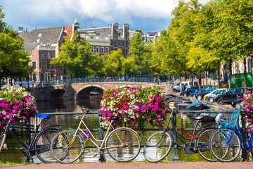 Naklejka premium Bicycles on a bridge over the canals of Amsterdam