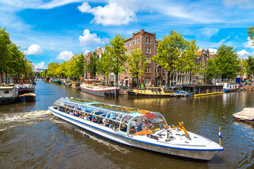 Amsterdam canals and  boats, Holland, Netherlands. - obrazy, fototapety, plakaty