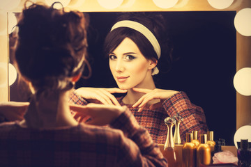 Portrait of a beautiful woman near a mirror