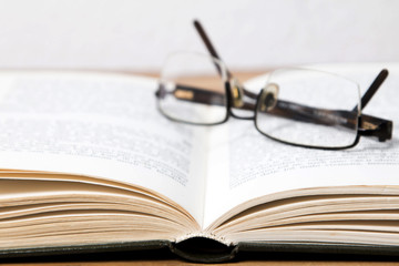 Glasses on open book