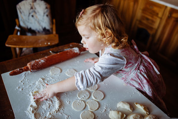 child preparing dough