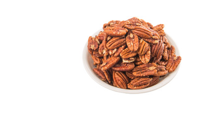Pecan nut in a white bowl over white background