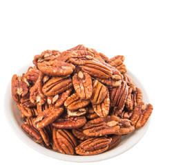 Pecan nut in a white bowl over white background