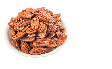 Pecan nut in a white bowl over white background
