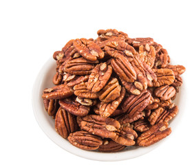 Pecan nut in a white bowl over white background