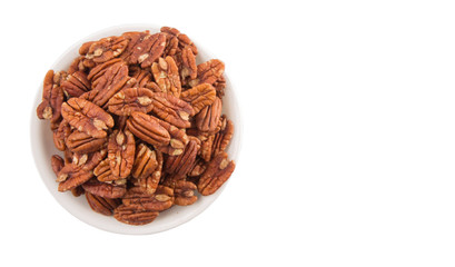Pecan nut in a white bowl over white background
