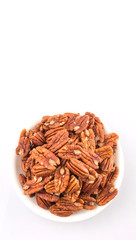 Pecan nut in a white bowl over white background