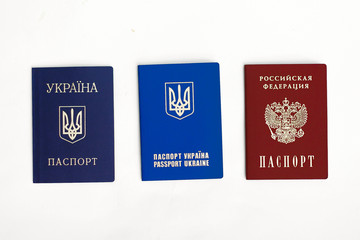 Ukrainian and Russian passports on white