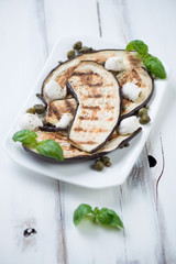 Grilled aubergines with capers, mozzarella and green basil