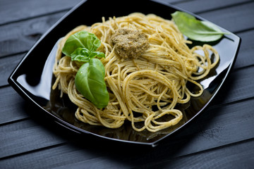 Still life food: spaghetti with basil pesto, studio shot