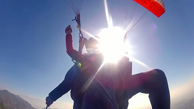 tandem paragliding over rocky mountains