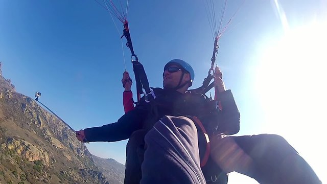 Paraglider against blue sky