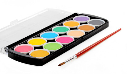 paints of different colors and slim paintbrush (brush)