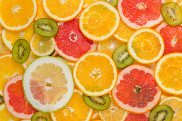 Fototapeta na wymiar Sliced healthy fruits background