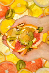 Fresh cutted fruits in woman hands