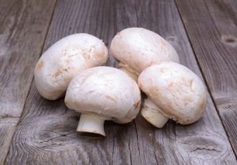Champignon on wooden background