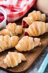 Fresh croissants with raspberries