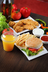 Fresh made burger with fires and crispy chicken.