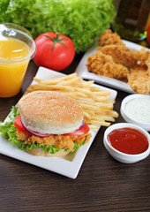 Fresh made burger with fires and crispy chicken.