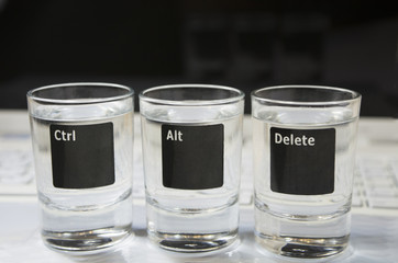 Laptop keyboard with “Ctr-Alt-Delete”  pictured on 3 glasses