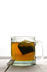Cup of green tea portrait center backlit