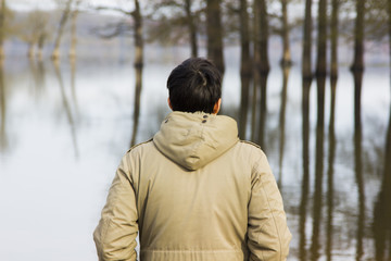 Man in jacket observing the river