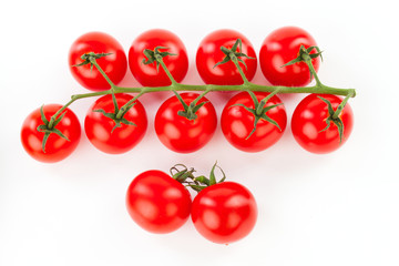 Juicy organic Cherry tomatoes with green leaf isolated over whit
