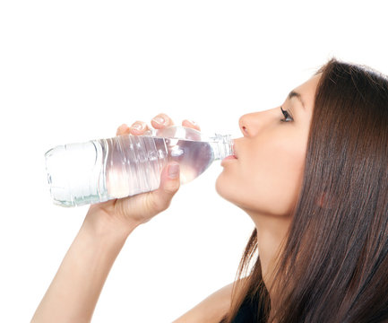 Woman drinking water from plastic bottle