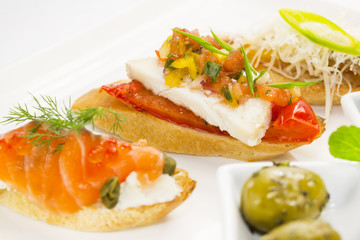 spanish sandwiches with seafood , cheese and vegetables