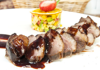 chicken breast with vegetables on a white plate