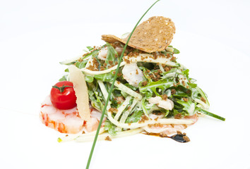 salad greens and shrimp meat on a white background