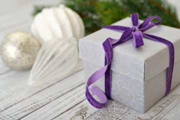 Gift box with violet ribbon