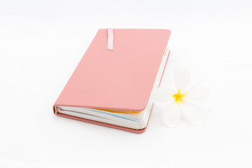 diary with plumeria flower