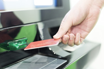 man insert credit card into ATM