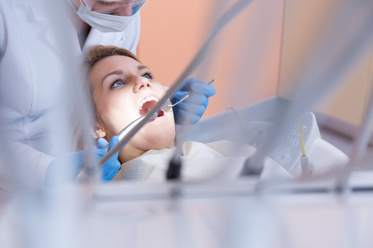 Dentistry examining patient's teeth