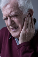 Senior man having toothache